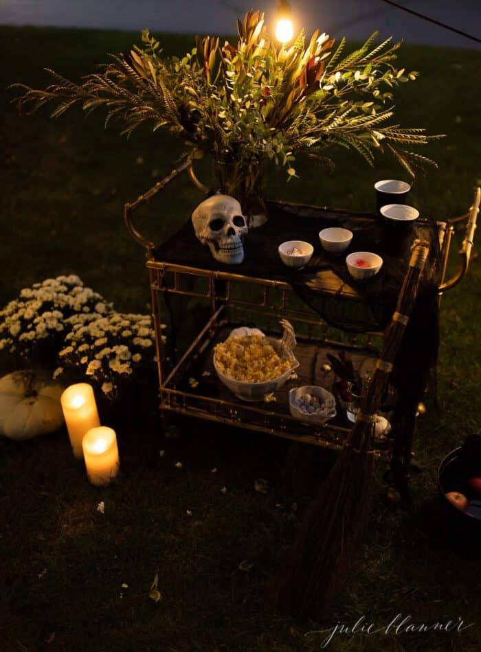 万圣节前夕在院子里布置的户外电影，有骷髅、蜡烛和装饰品。