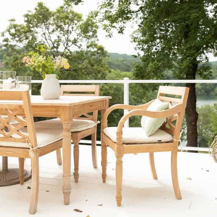柚木家具，餐厅设置在白色的露台上，有玻璃栏杆。