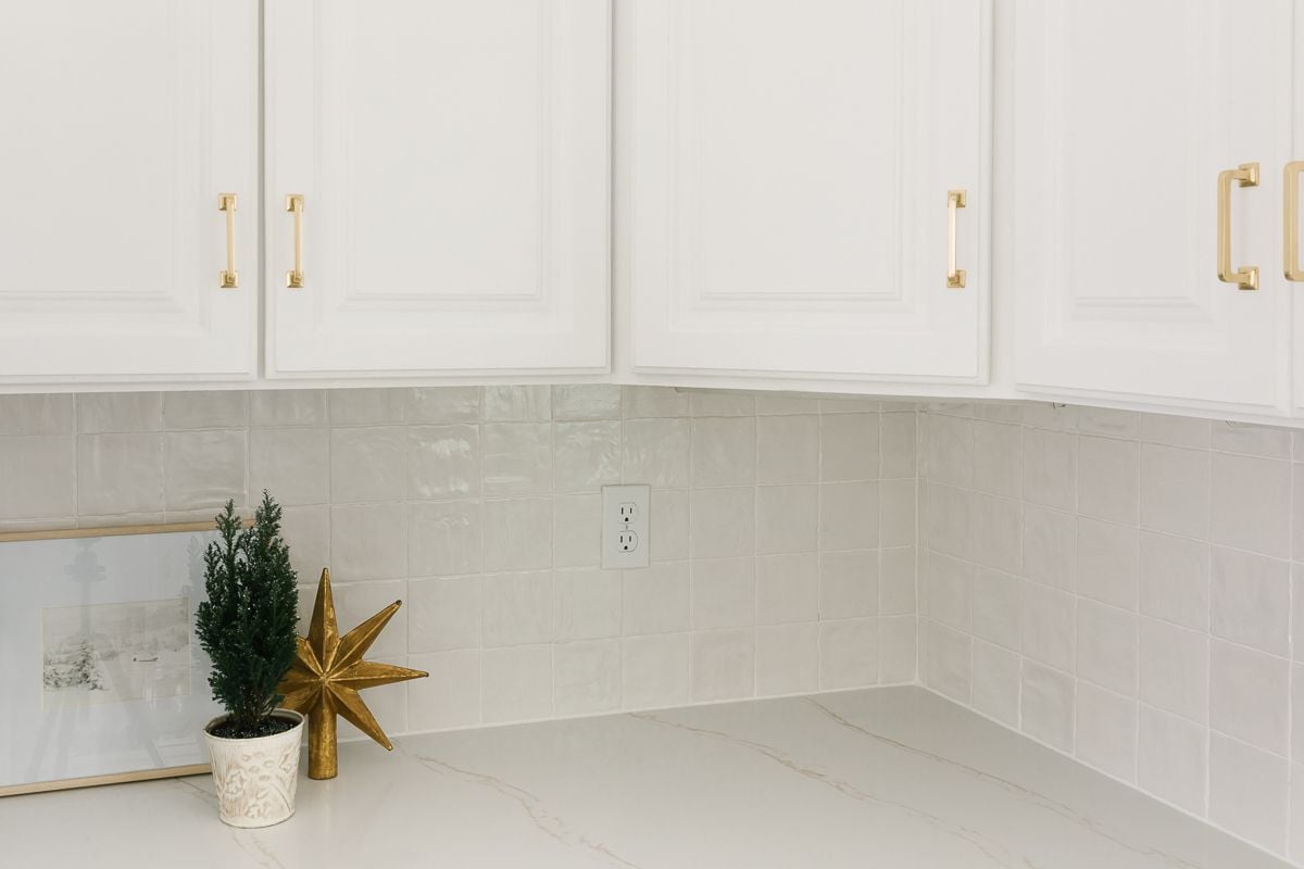白色厨房橱柜与白色瓷砖后挡板，与白色聚混浆料颜色