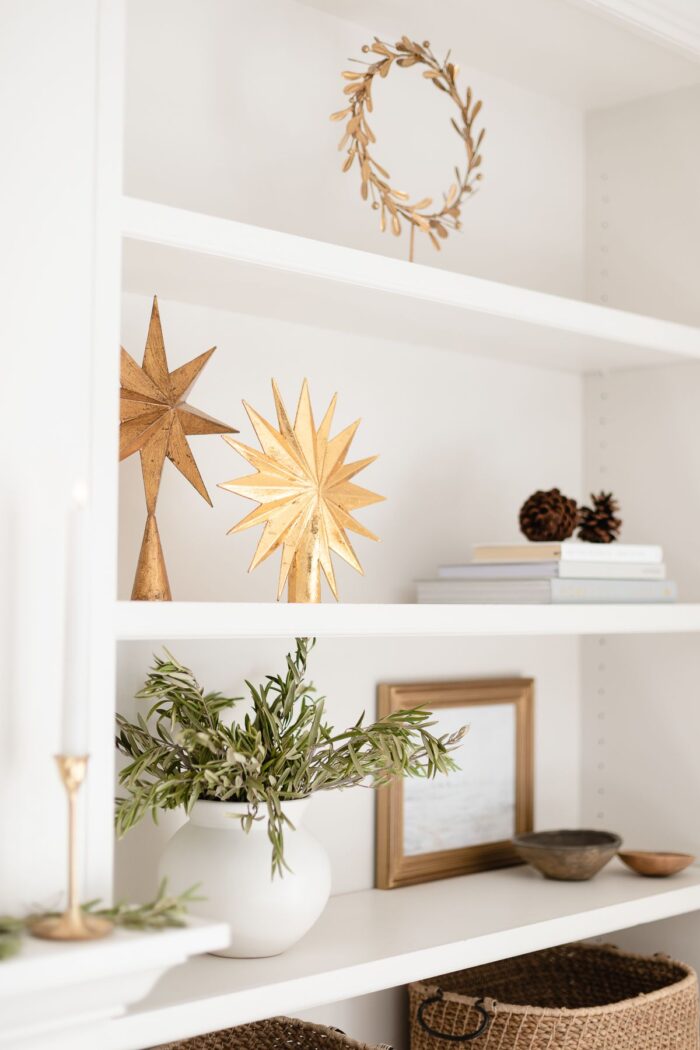 金色的星星和传统的圣诞花环装饰在白色的架子上